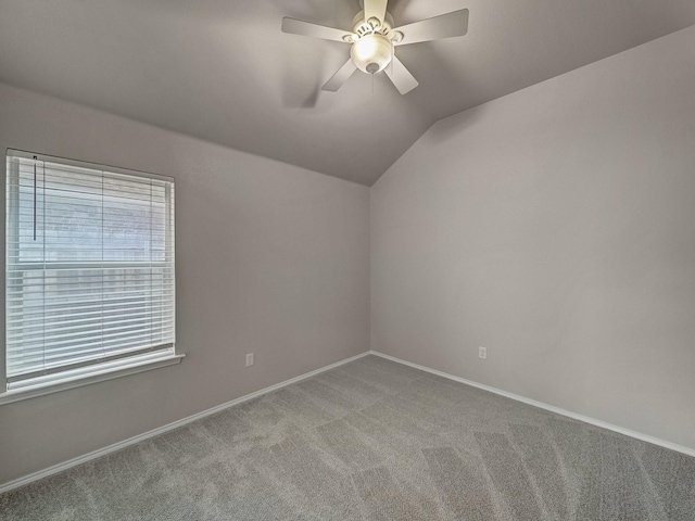 unfurnished room featuring ceiling fan, carpet flooring, and vaulted ceiling