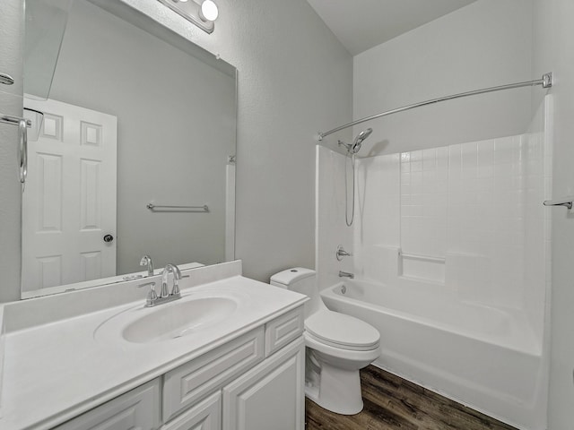 full bathroom with hardwood / wood-style flooring, shower / tub combination, vanity, and toilet