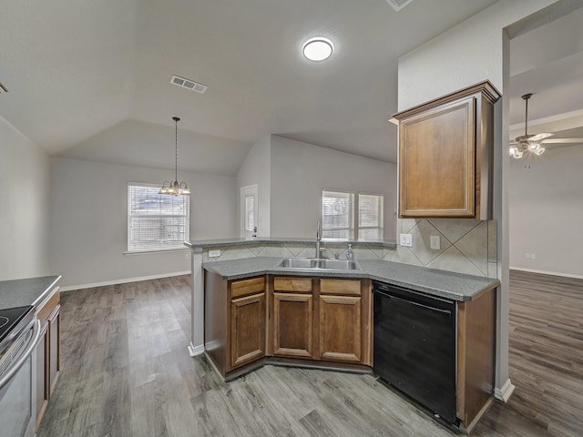 821 Grace Ln, Saginaw, TX 76179 - kitchen with black dishwasher, a sink, wood finished floors, a peninsula, and lofted ceiling