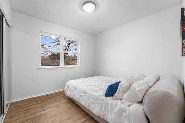 bedroom featuring hardwood / wood-style flooring and a closet