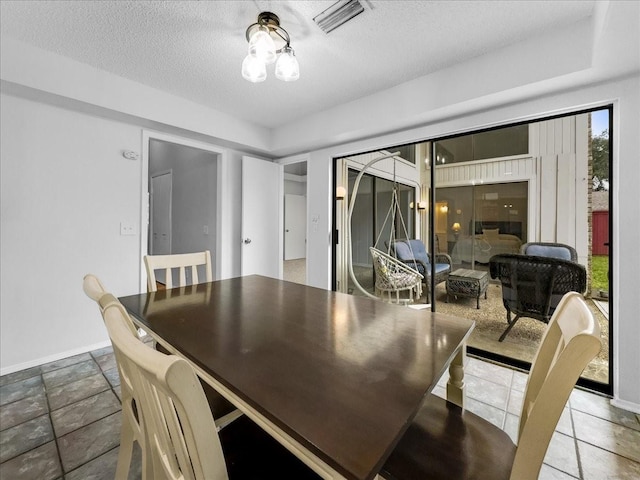 dining room featuring a textured ceiling