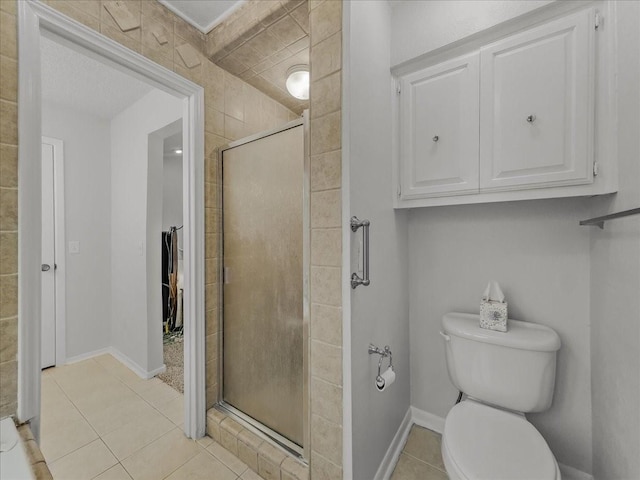 bathroom featuring walk in shower, tile patterned floors, and toilet