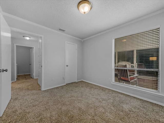 unfurnished bedroom featuring crown molding, carpet flooring, a textured ceiling, and a closet