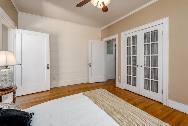 bedroom with crown molding, wood-type flooring, french doors, and ceiling fan