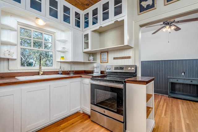 kitchen with white cabinetry, sink, and electric stove