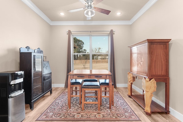 dining room with ornamental molding, ceiling fan, and light hardwood / wood-style floors