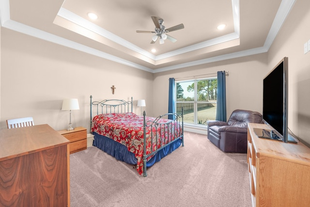 bedroom featuring crown molding, ceiling fan, carpet flooring, and a raised ceiling