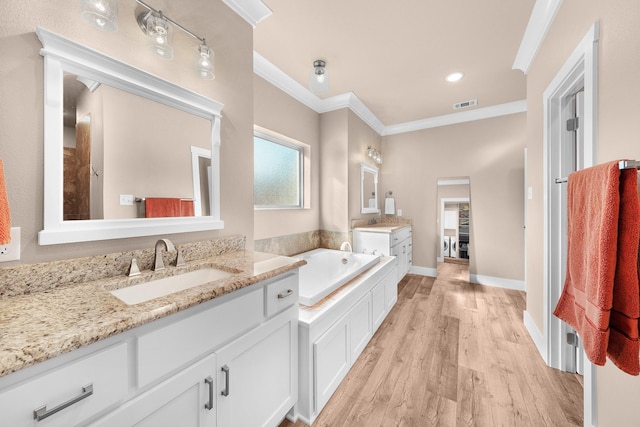 bathroom with vanity, hardwood / wood-style floors, crown molding, and a tub to relax in