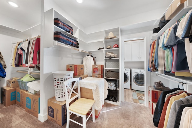 spacious closet with carpet floors and washing machine and clothes dryer