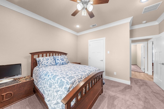 carpeted bedroom featuring ornamental molding and ceiling fan