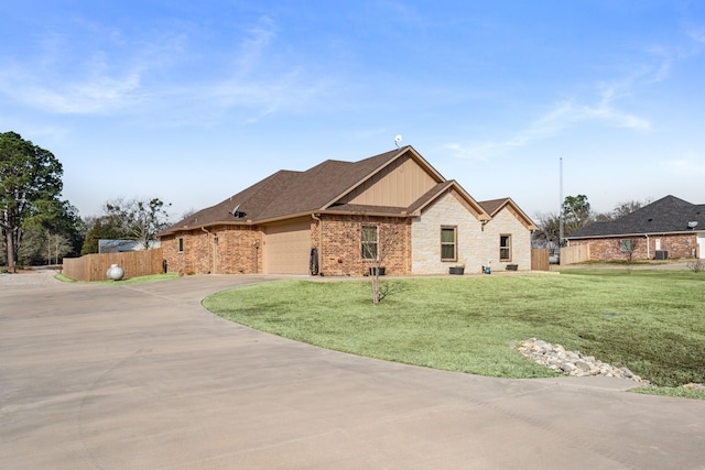 view of front of house featuring a garage and a front lawn