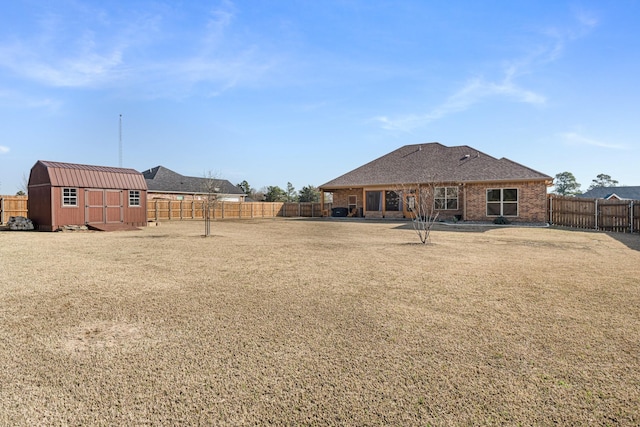 rear view of property featuring a storage unit