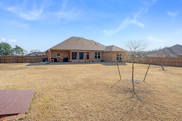 back of property featuring a lawn and a patio area