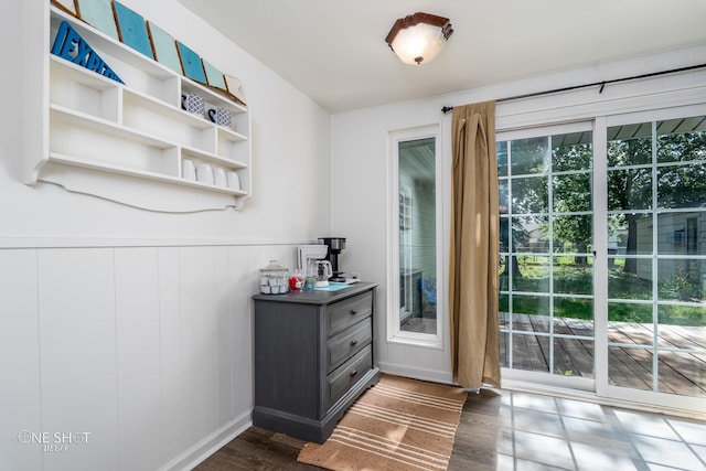 doorway to outside with dark wood-type flooring and a wealth of natural light