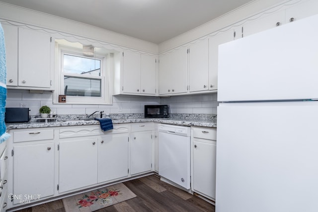 kitchen featuring white cabinetry, backsplash, and white appliances