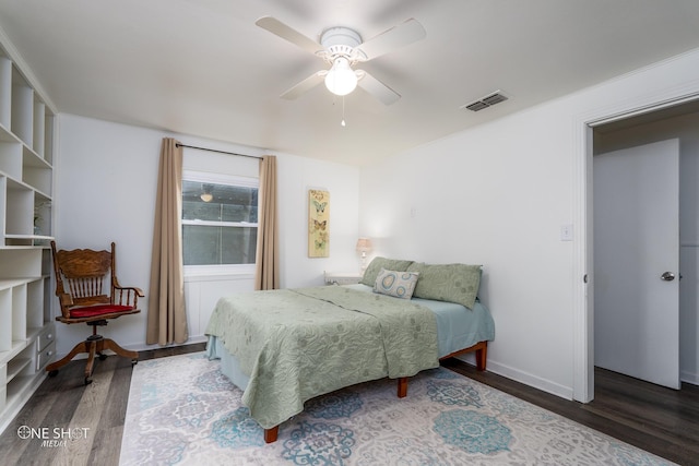 bedroom with dark hardwood / wood-style flooring and ceiling fan