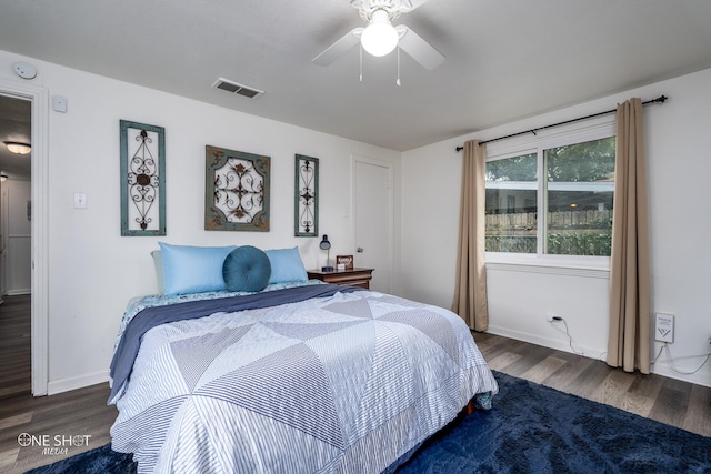 bedroom with dark hardwood / wood-style floors and ceiling fan