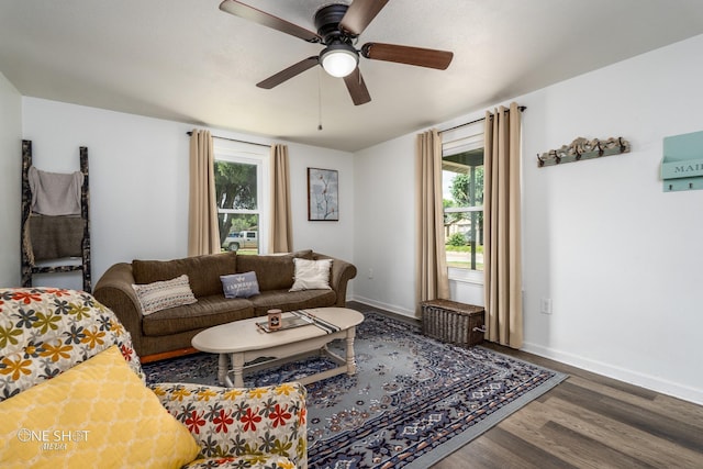 living room featuring ceiling fan and dark hardwood / wood-style flooring