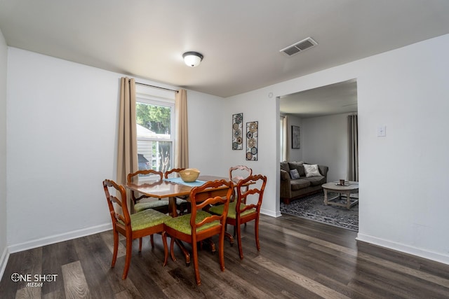 dining space featuring dark hardwood / wood-style floors