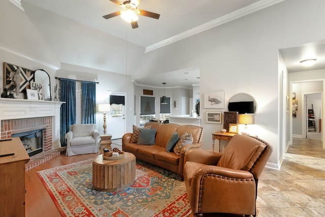 living room with ornamental molding, ceiling fan, a fireplace, and high vaulted ceiling