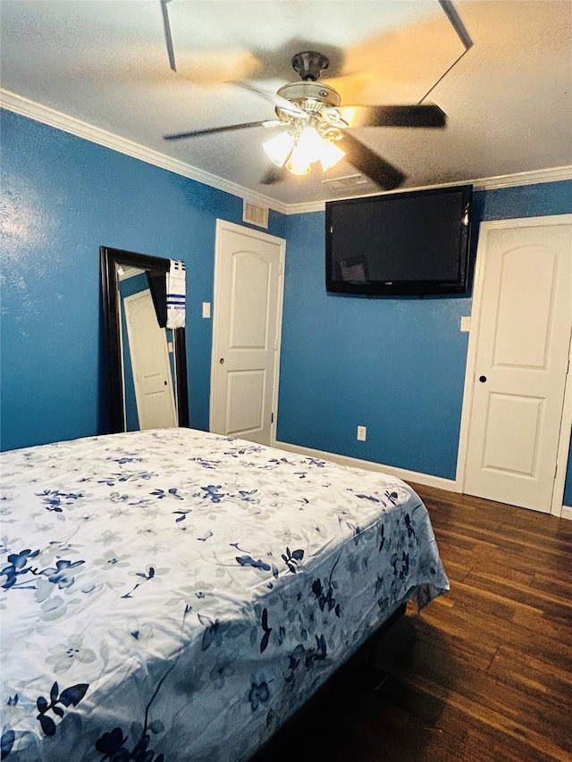 bedroom with ceiling fan, ornamental molding, and dark hardwood / wood-style floors