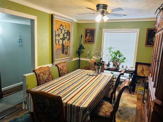 dining area featuring wood-type flooring, a textured ceiling, and crown molding