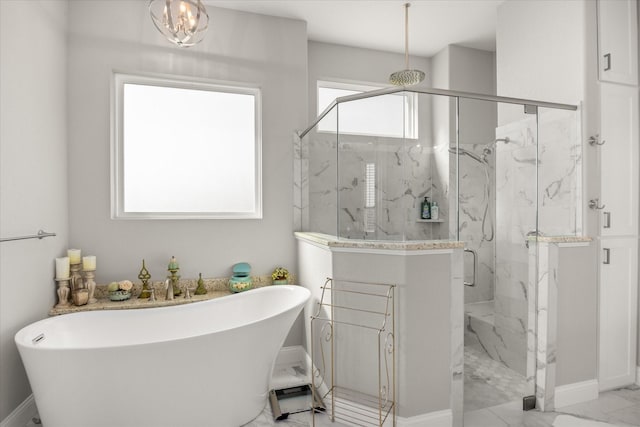 full bathroom with a freestanding tub, baseboards, a marble finish shower, and marble finish floor