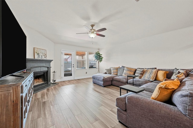 living room featuring ceiling fan and light wood-type flooring