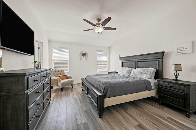 bedroom featuring hardwood / wood-style flooring, lofted ceiling, and ceiling fan