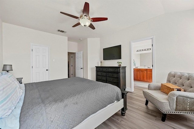 bedroom featuring ceiling fan, connected bathroom, and light hardwood / wood-style flooring