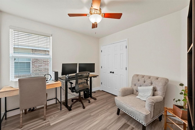 office area with light hardwood / wood-style floors and ceiling fan