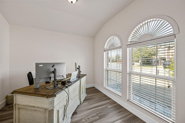 office featuring vaulted ceiling and light hardwood / wood-style floors