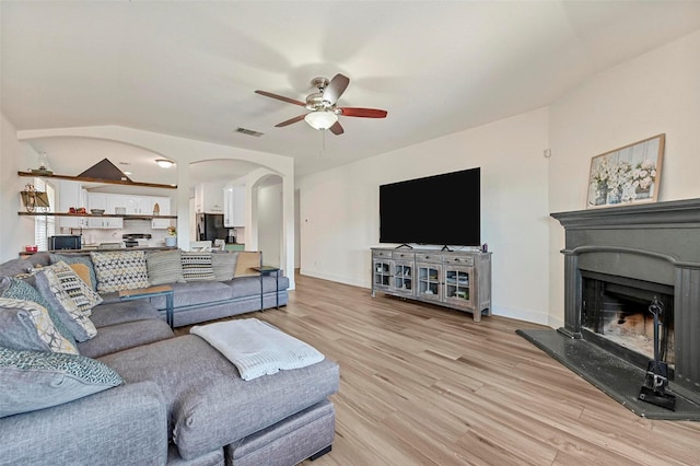 living room with ceiling fan and light hardwood / wood-style floors