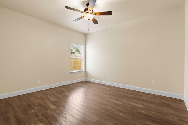 spare room with dark hardwood / wood-style flooring and ceiling fan