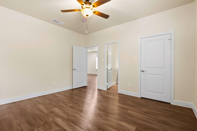 unfurnished bedroom with dark wood-type flooring