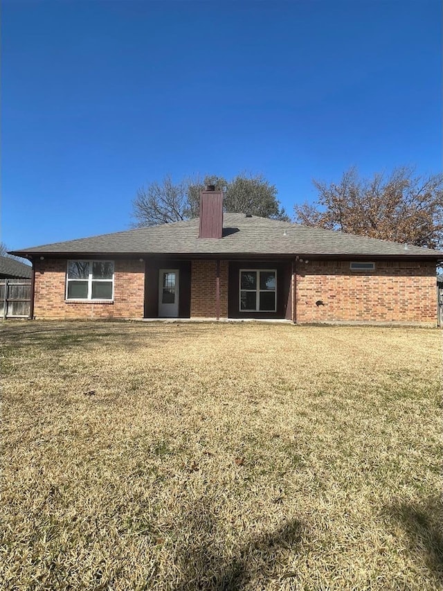 back of property with a lawn