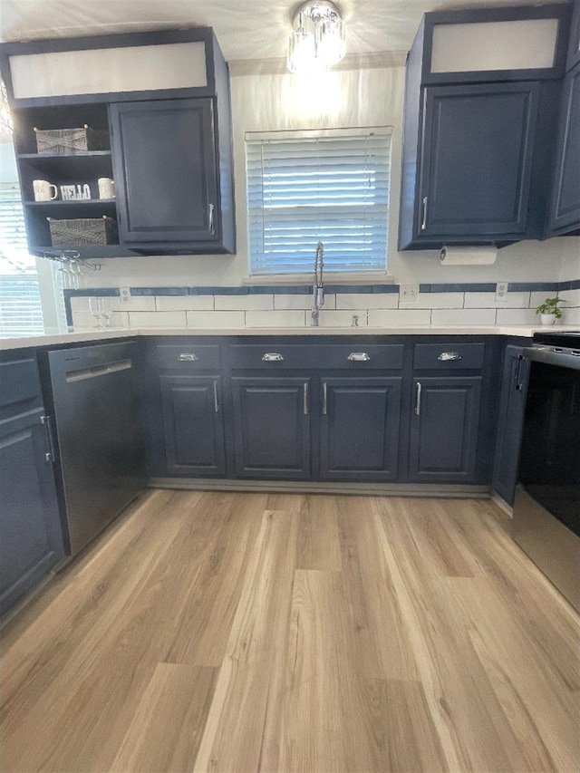 kitchen featuring sink, dishwasher, and light hardwood / wood-style floors