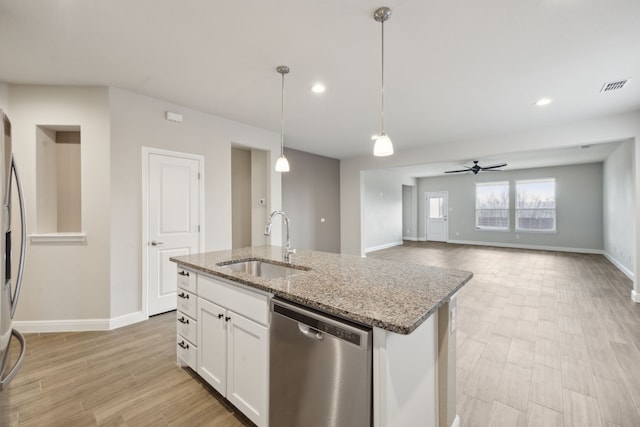 kitchen featuring white cabinetry, dishwasher, sink, hanging light fixtures, and a kitchen island with sink