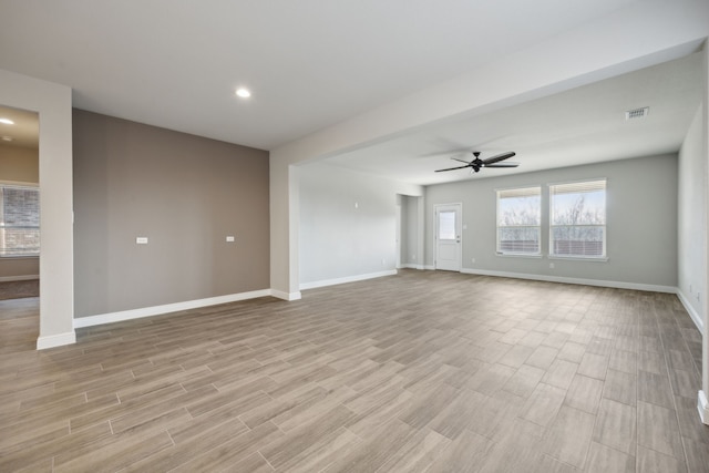 unfurnished living room with ceiling fan