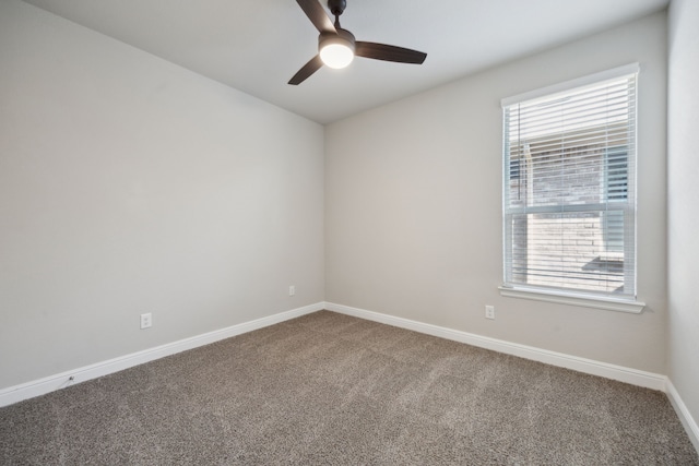 empty room featuring plenty of natural light, carpet floors, and ceiling fan