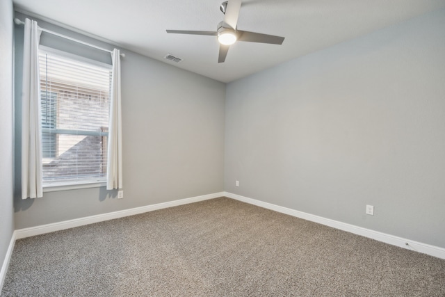 spare room featuring ceiling fan and carpet