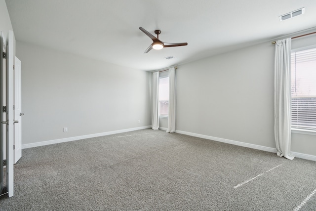 unfurnished room featuring ceiling fan and carpet flooring