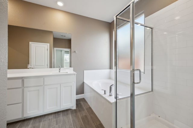 bathroom with independent shower and bath and vanity