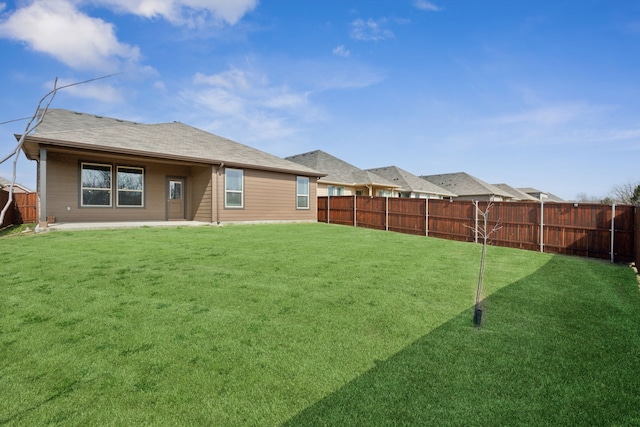 rear view of property featuring a patio and a lawn