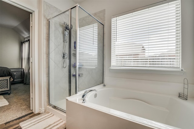 bathroom featuring a healthy amount of sunlight and plus walk in shower
