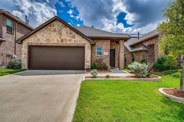 view of front of property with a garage and a front yard