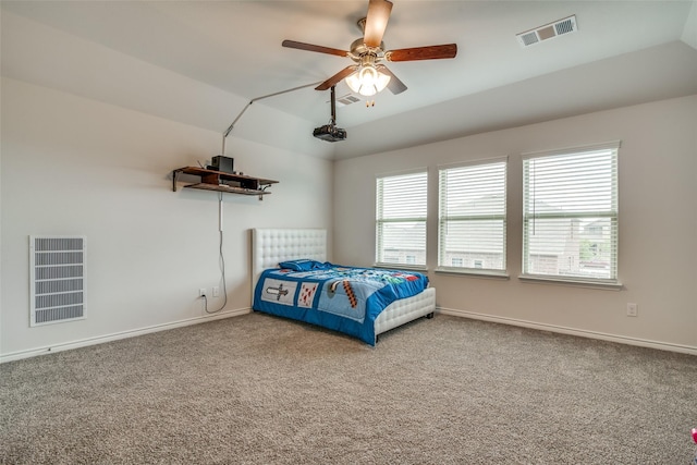 carpeted bedroom featuring lofted ceiling and ceiling fan