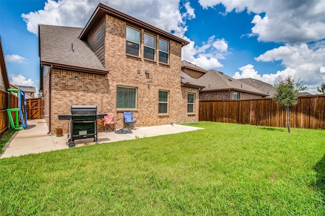 back of house with a yard and a patio area