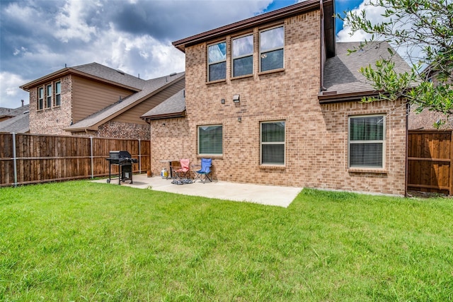 back of house with a lawn and a patio