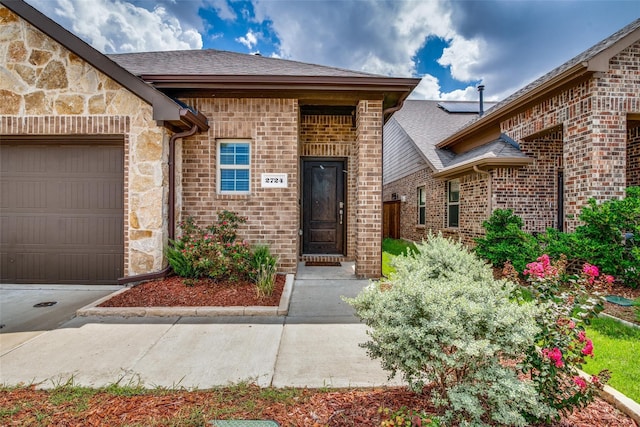 doorway to property featuring a garage